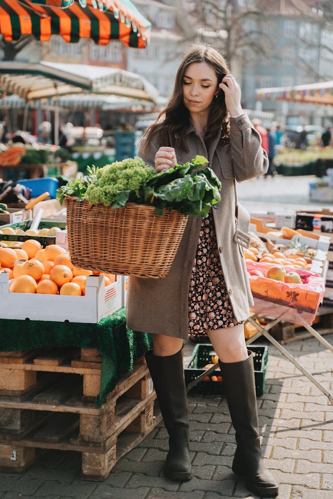 A woman in a brown coat selects fresh vegetables at an outdoor market in Erfurt, Germany.