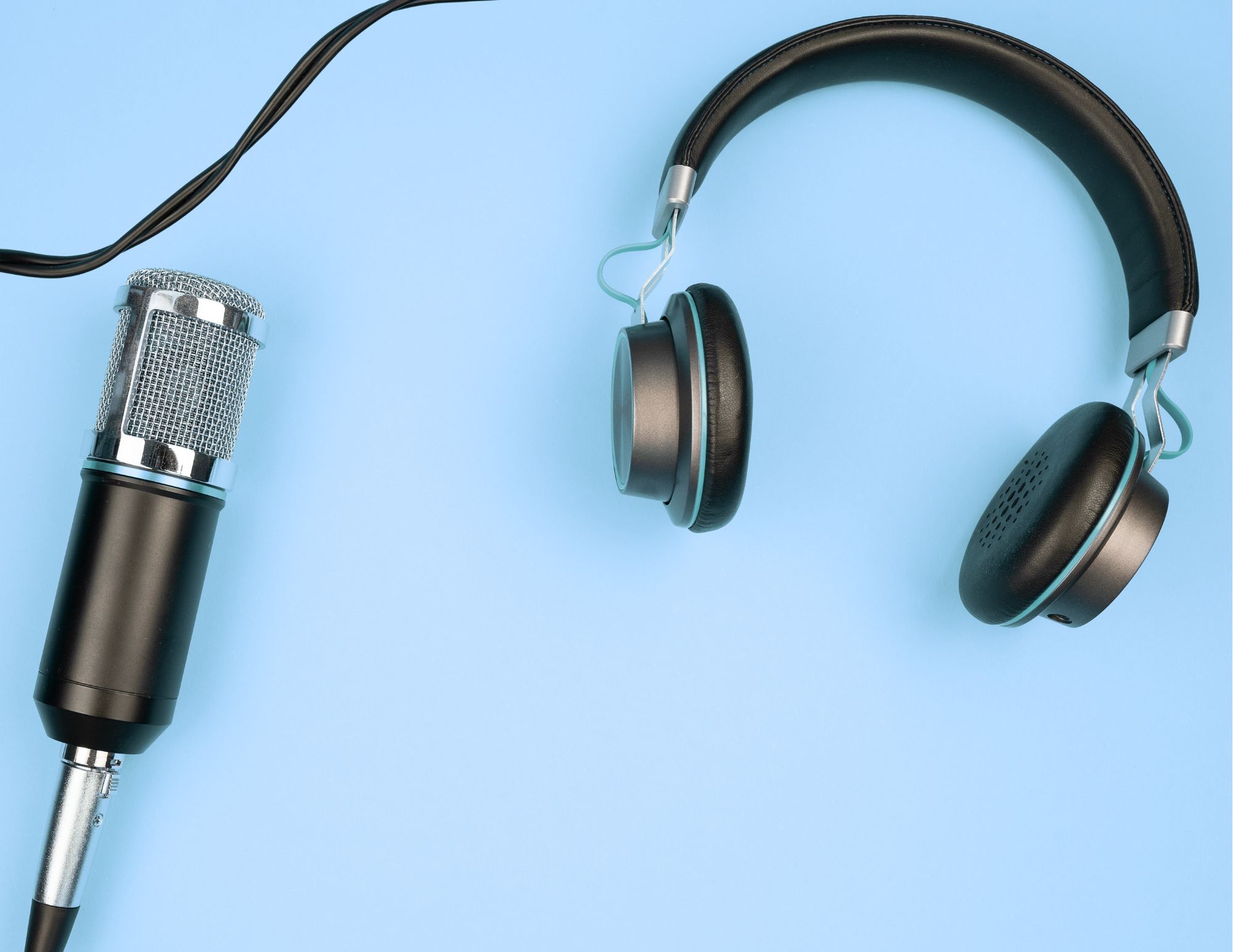 a podcast microphone and headphones on a blue background
