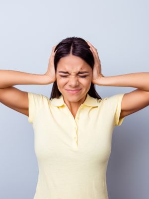 woman anxious and stressed out by loud noises